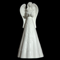 A white ceramic angel figurine with detailed embossed patterns on its dress and wings, set against a solid black background.
