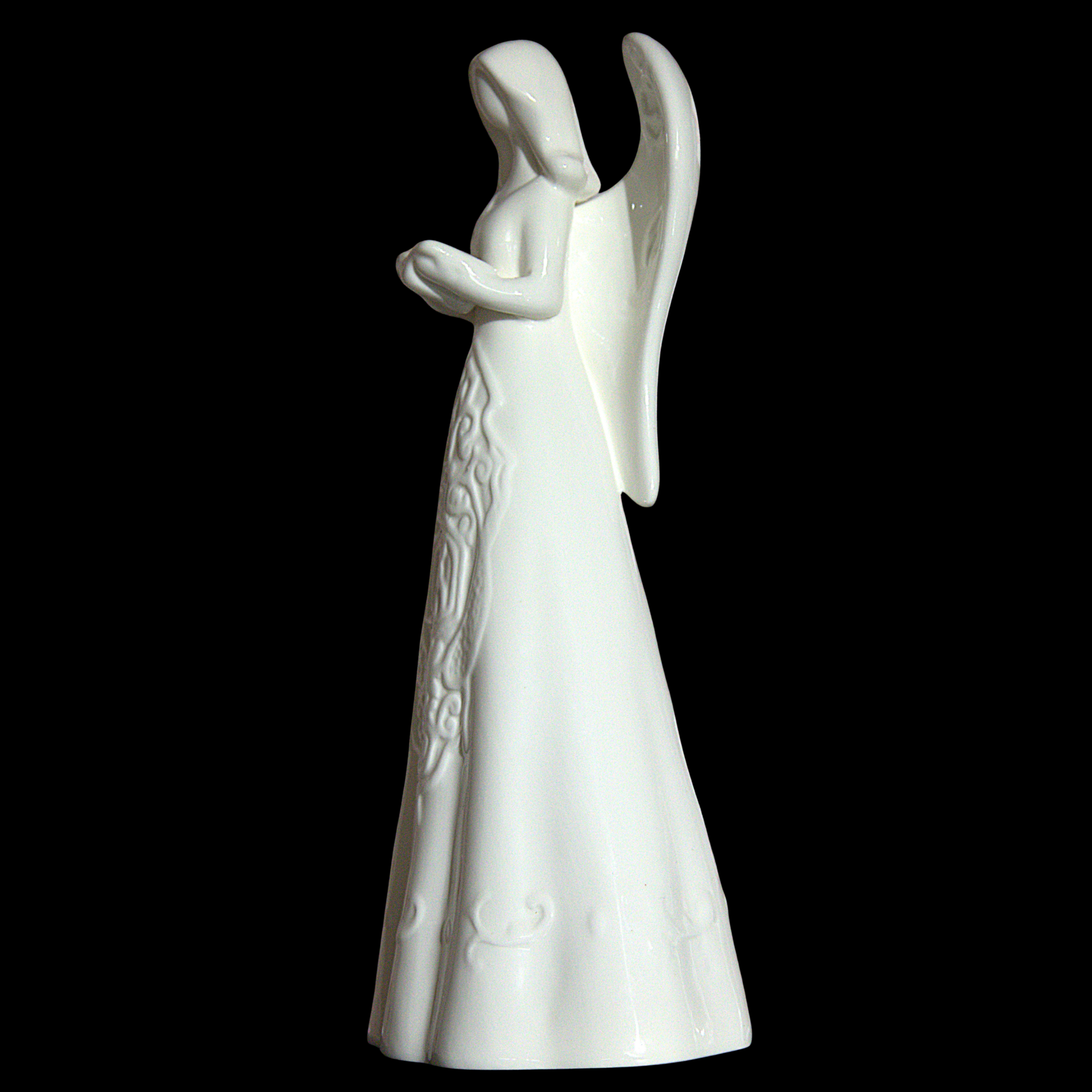 A white ceramic angel figurine with outstretched wings and a long dress, shown against a solid black background.