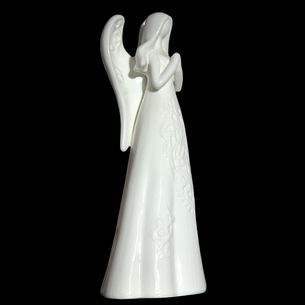 A glossy white ceramic angel figurine with wings and a long gown, standing against a solid black background.