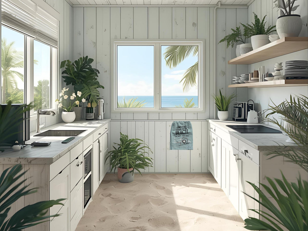 A bright, modern kitchen with white shiplap walls, white cabinets, marble countertops, and an ocean view through the center window. The kitchen is decorated with several potted green plants and has open wooden shelves on the right side.