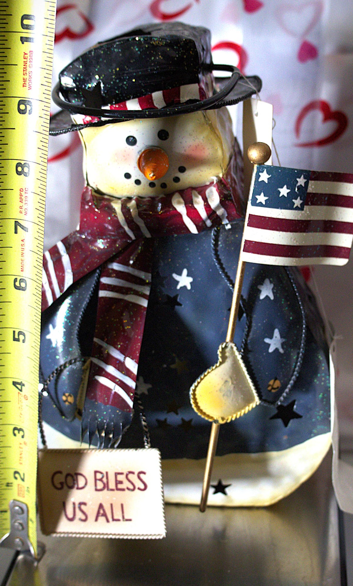 Vintage hand-painted patriotic snowman tea light lantern featuring red, white, and blue Americana Christmas décor with festive winter holiday charm.